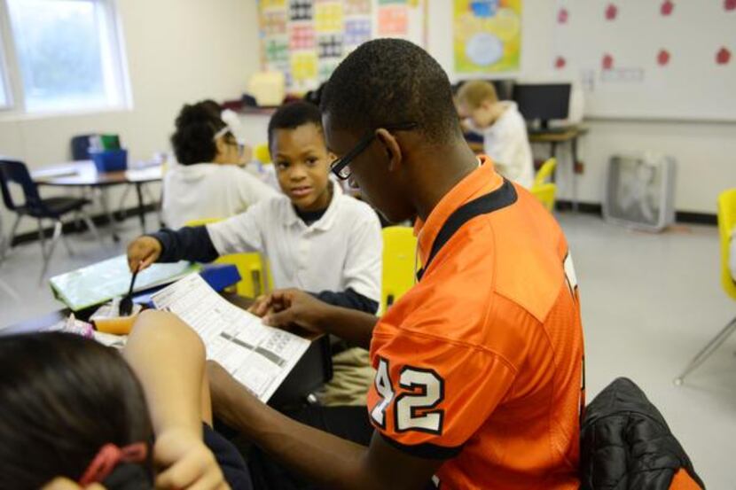 
Junior Desmond Davisa football player at North Dallas High School, tutors fourth-grader...