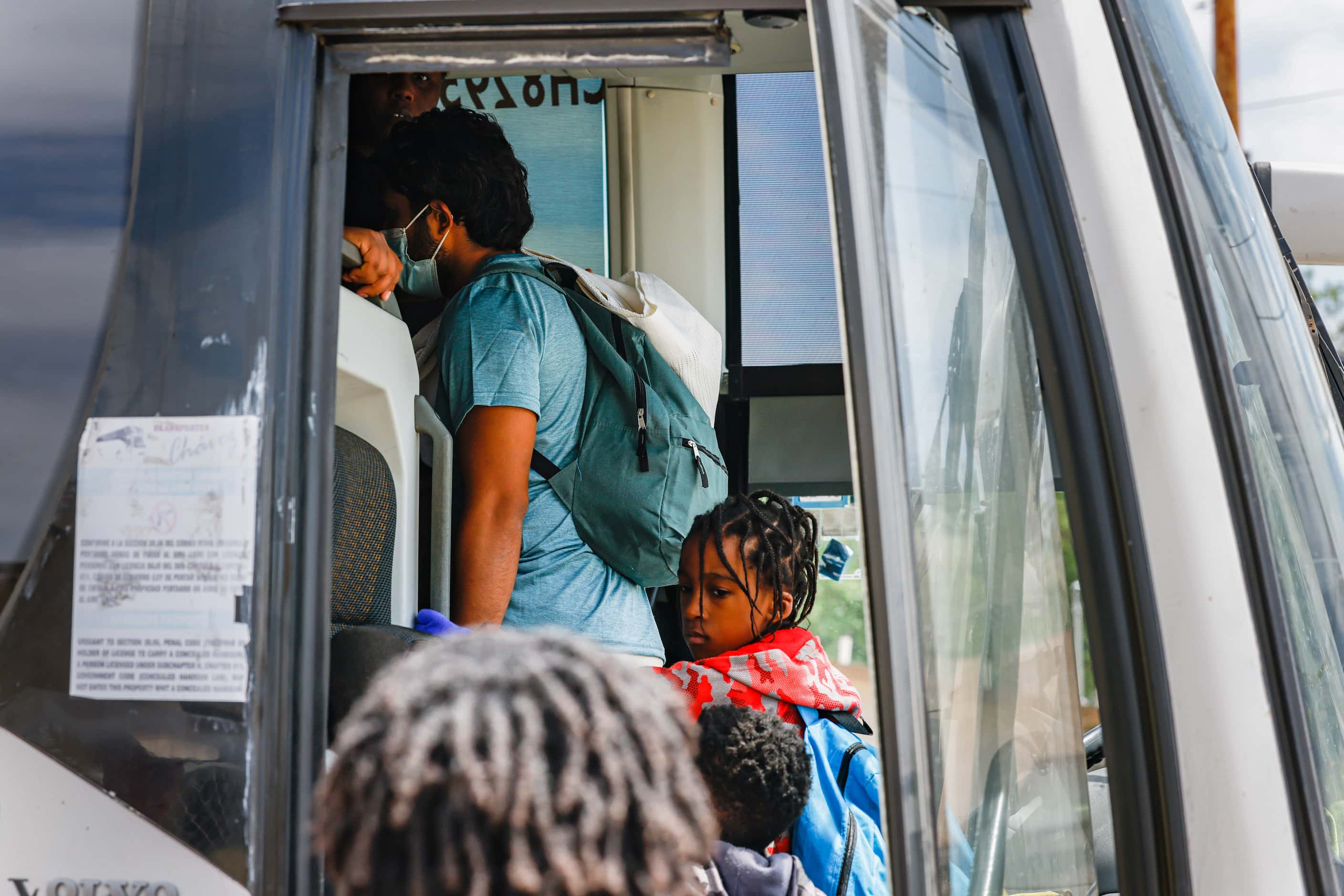 Victor Rodriguez, 26, aboards the bus that will take him along with other migrants to the...