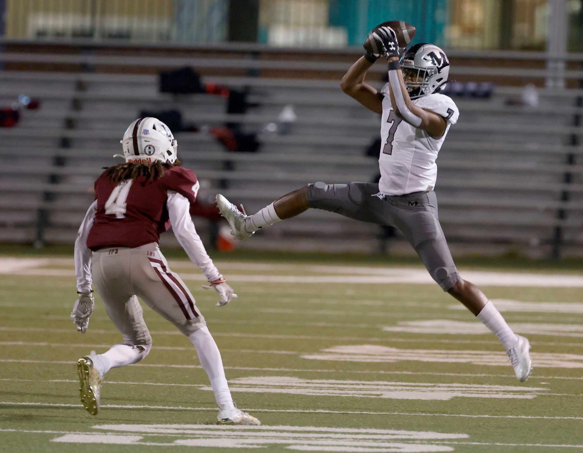 Arlington Martin’s Kyron Askey (7) catches a pass in front of Lewisville defender Kamon...