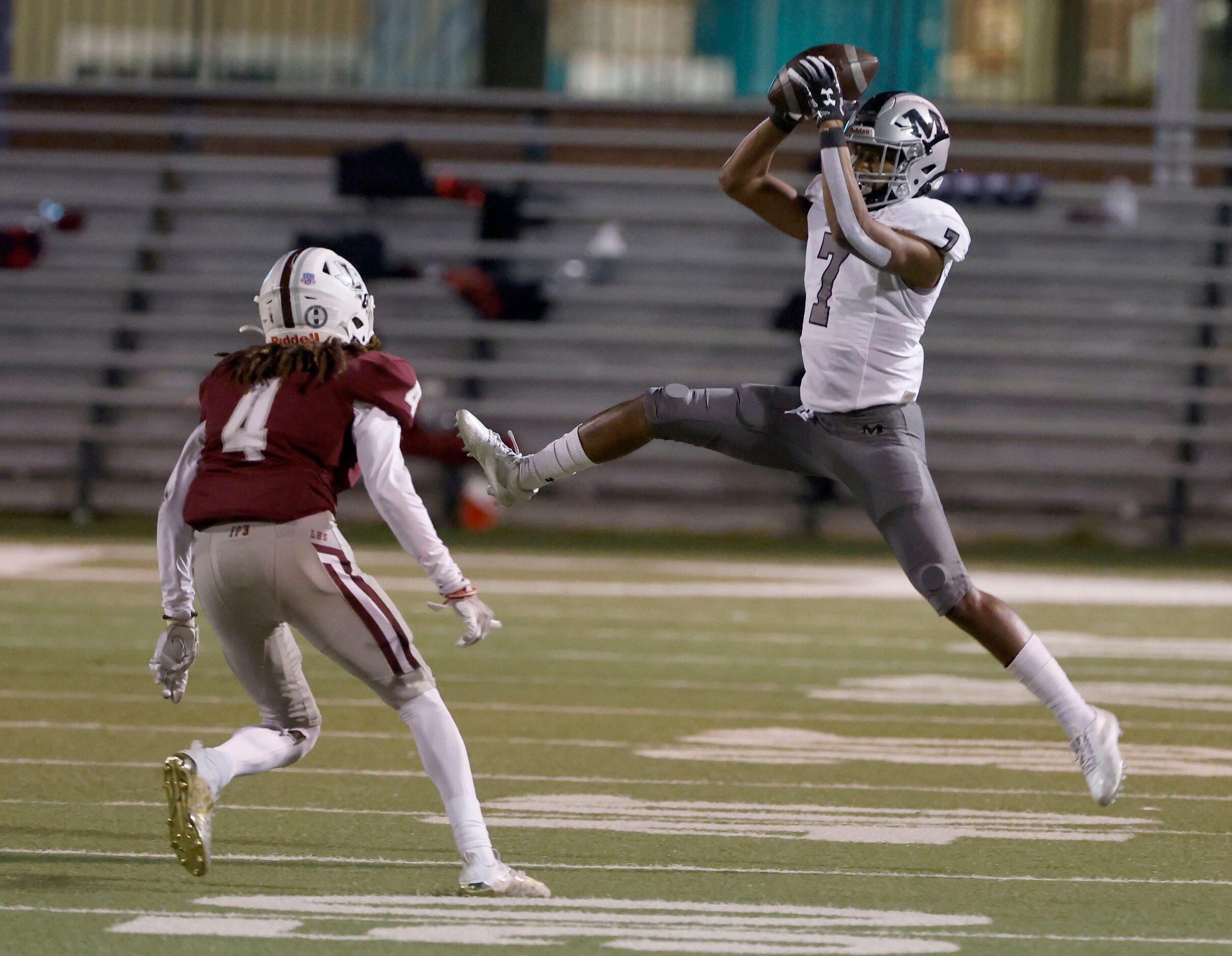 Arlington Martin’s Kyron Askey (7) catches a pass in front of Lewisville defender Kamon...