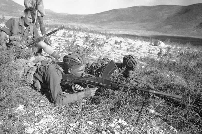 British outposts in Acre district operate machine guns against Arab rebels in Acre,...