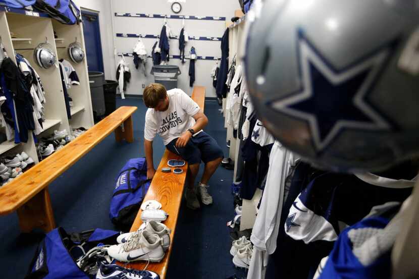 Dallas Cowboys Jon Speck works on packing a game bag for Saturday's preseason game in the...
