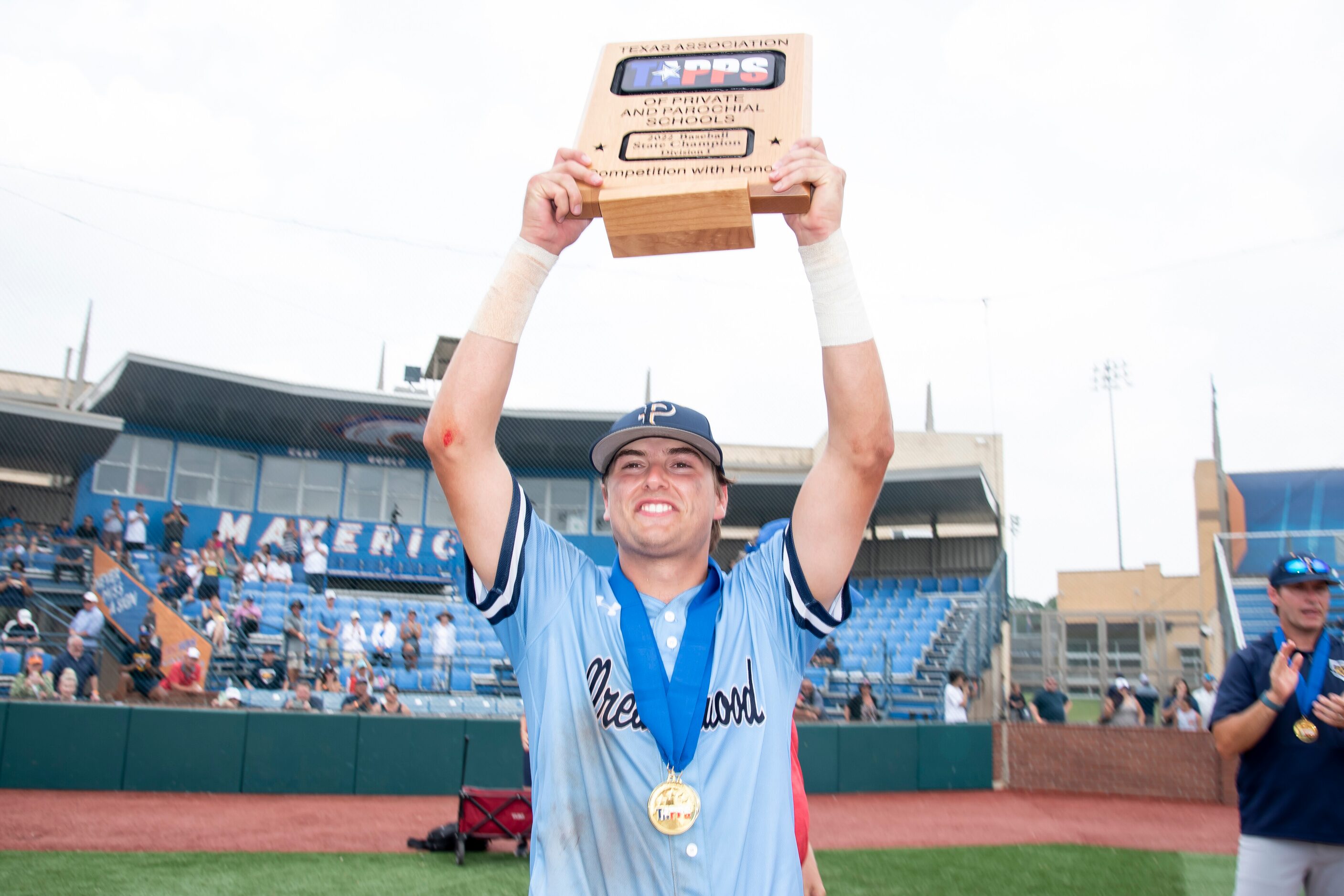 Prestonwood senior Tate Trammel (1) hoists the TAPPS Division I baseball state championship...