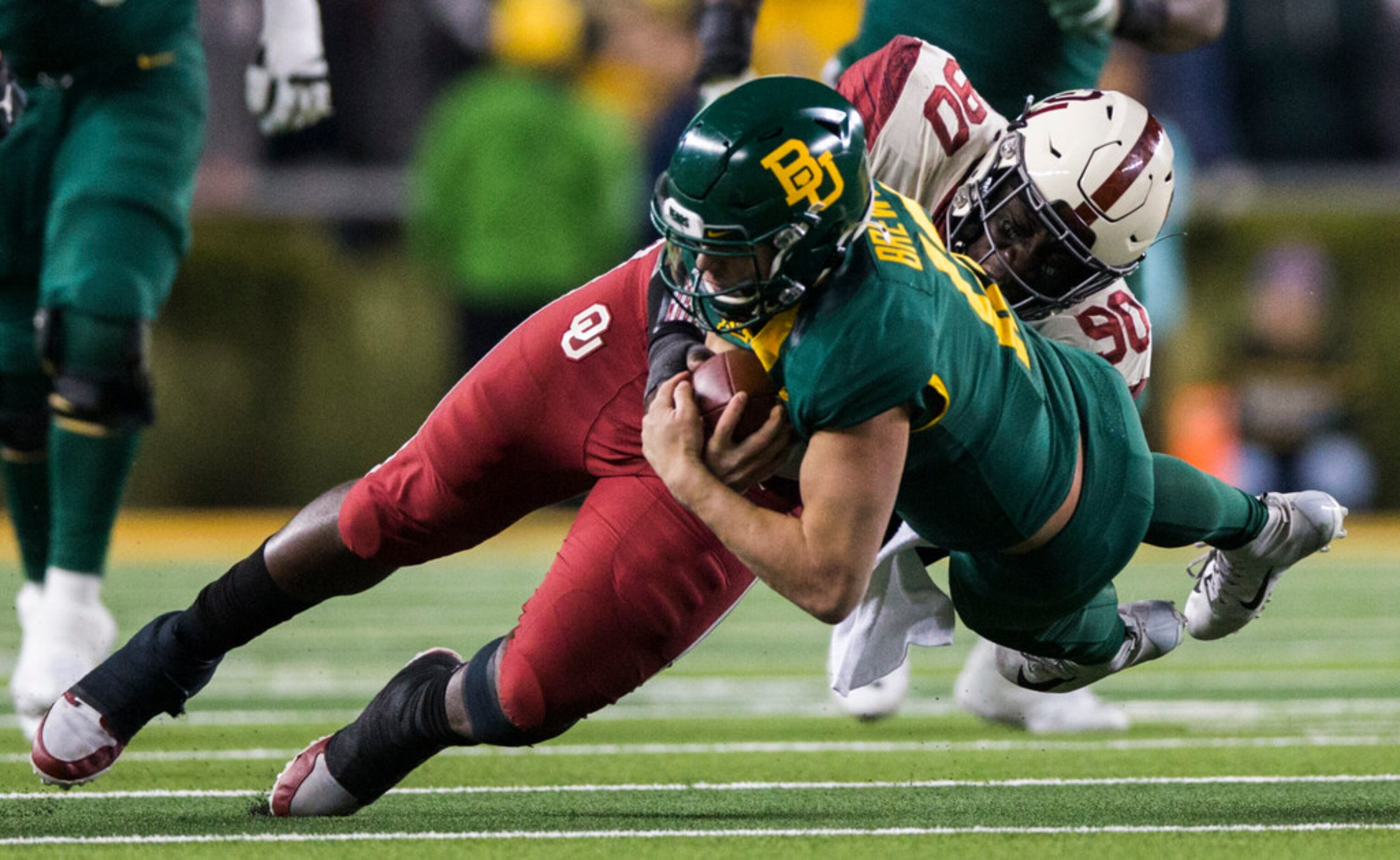 Baylor Bears quarterback Charlie Brewer (12) is tackled by Oklahoma Sooners defensive...