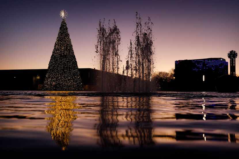 The Christmas tree at Dallas City Hall is reflected in the fountain pool in downtown Dallas.