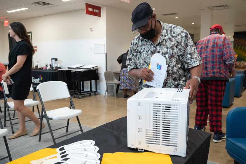 Allen Thomas, 71, who currently does not have air condition in his apartment, looks at an AC...