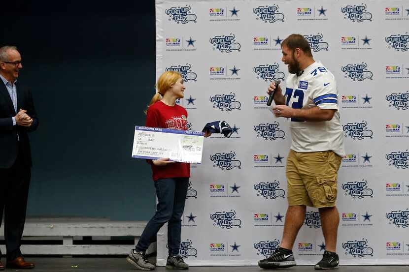 Cowboys center Travis Frederick, right, talks with Jewell Sterling,  who is named the SAP...