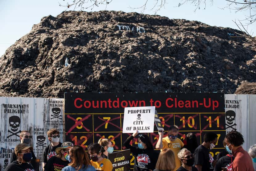 Amber Wang, a board member for Downwinders at Risk, held a sign reading "property city of...