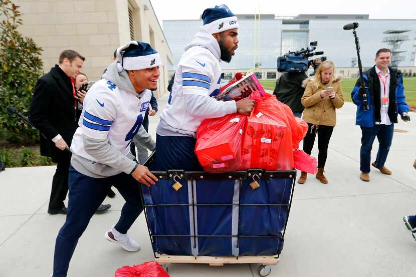 Dallas Cowboys quarterback Dak Prescott (4) carries the load for a change, pushing running...