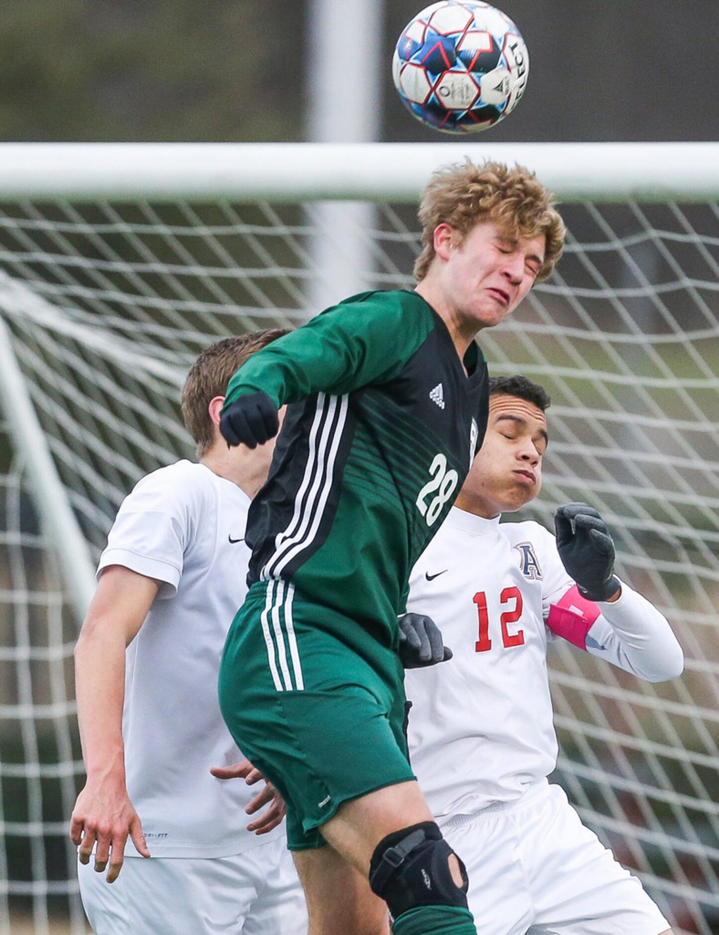 Prosper's Brycen Drew (28) heads the ball past Allen's Edwin Shivers (12) during Prosper's...