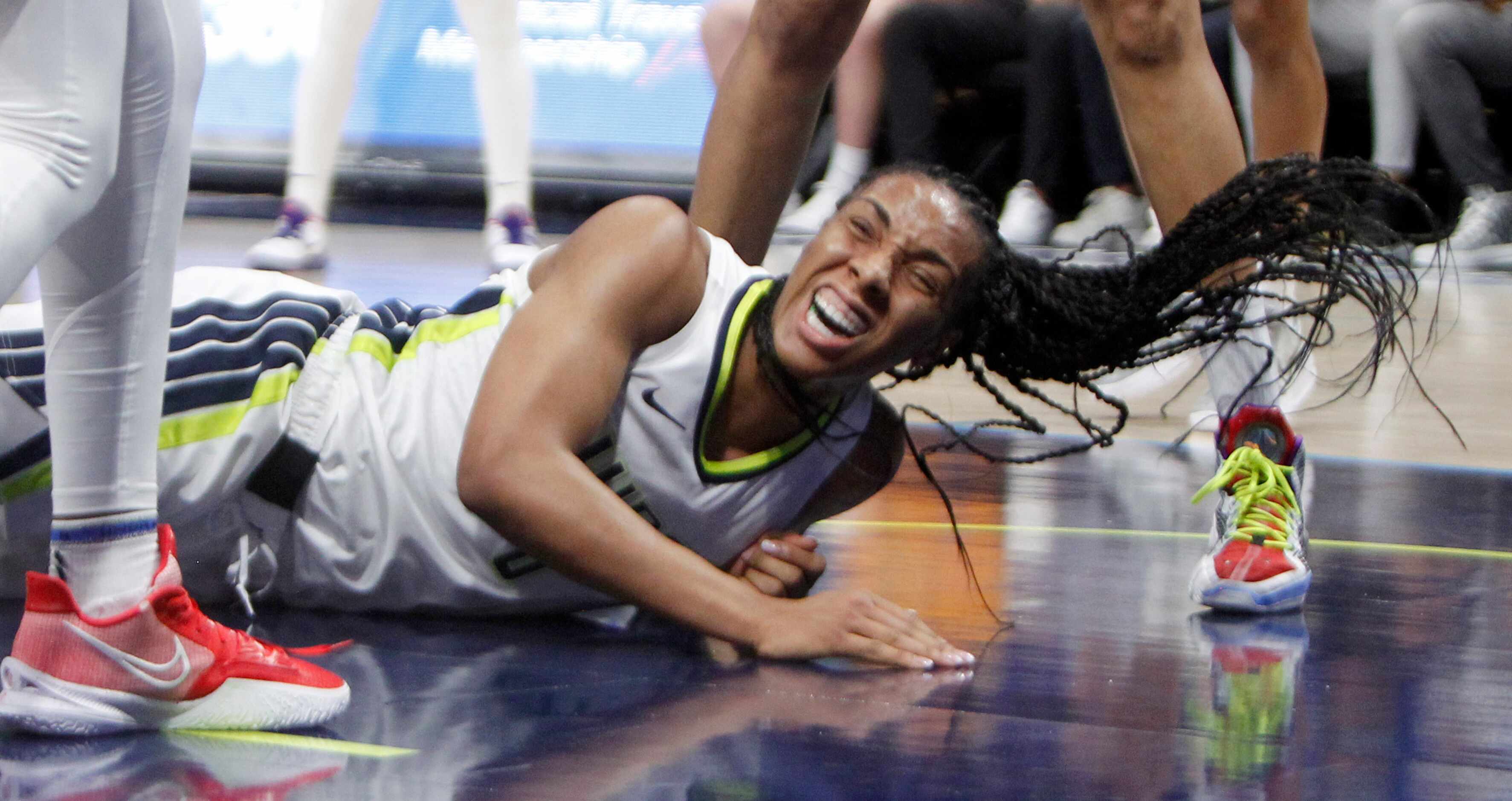 Dallas Wings forward Kayla Thornton (6) winces after being fouled while shooting by...