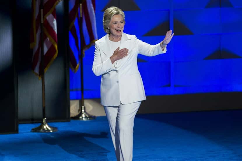 Democratic presidential candidate Hillary Clinton waves to supporters as she takes the stage...