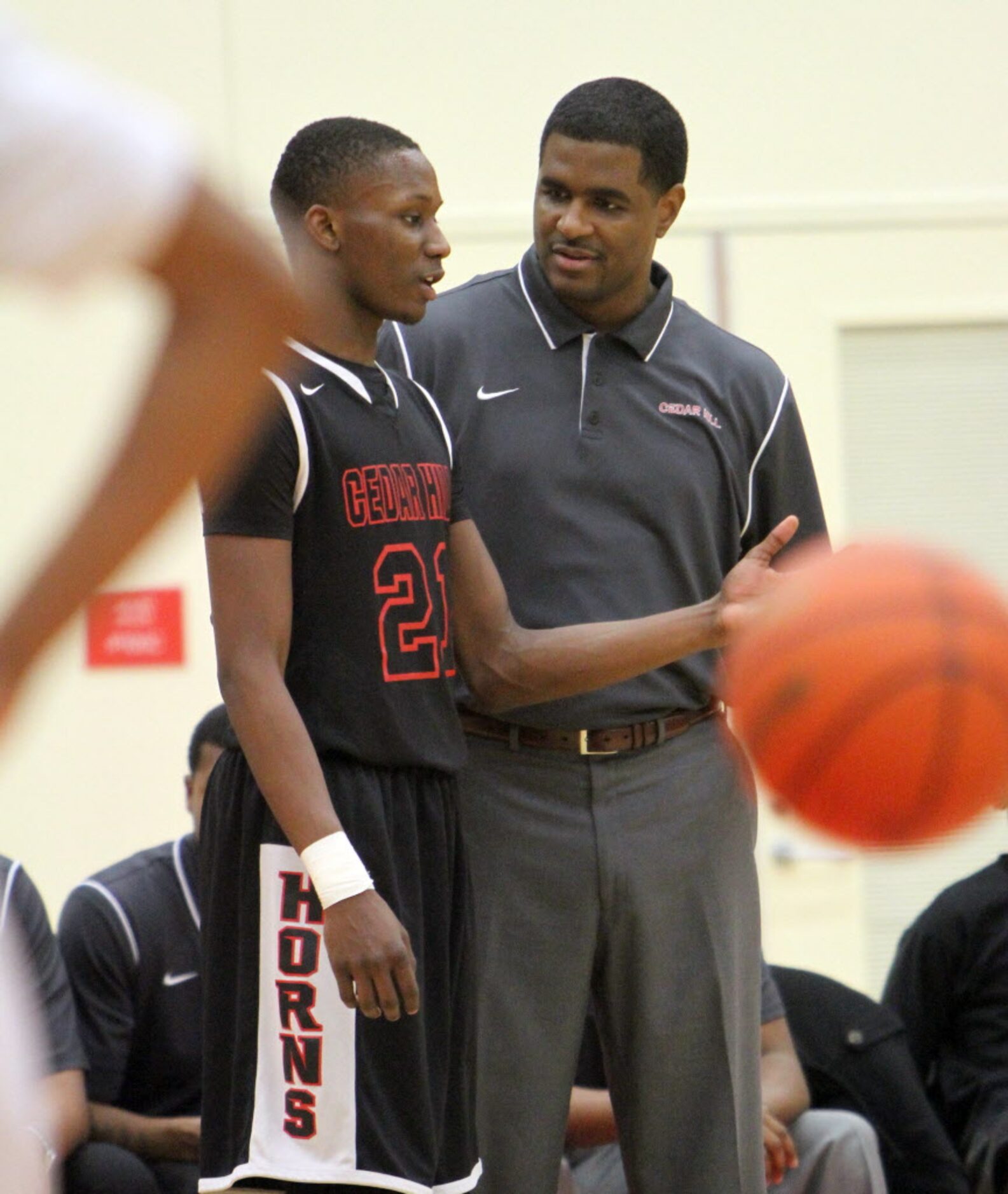 Cedar Hill head coach Brandon Thomas speaks with Longhorns forward Jordan Terry (21) during...