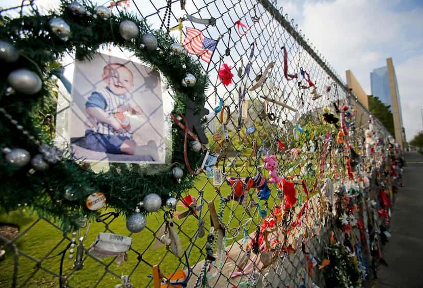 
A picture of Kevin Lee Gottshall II joins other tributes on the fence around the memorial....