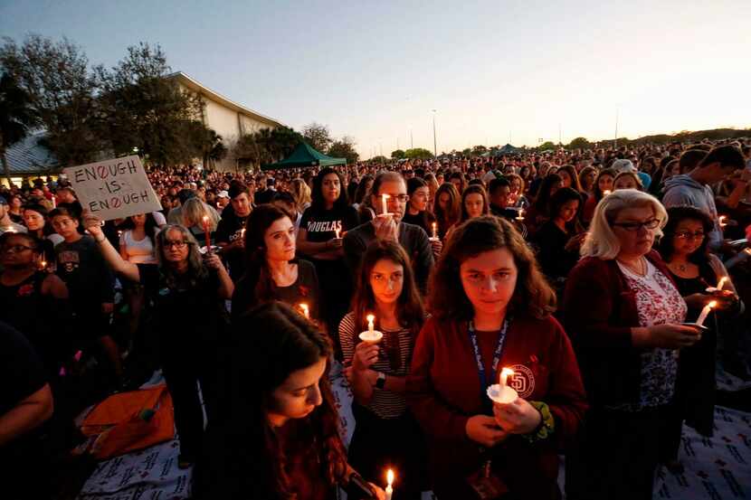 TOPSHOT - Thousands of mourners hold candles during a candlelight vigil for victims of the...