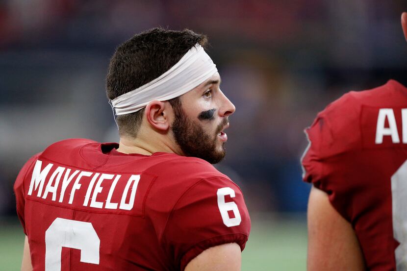 FILE - Oklahoma quarterback Baker Mayfield (6) visits with a teammate on the sideline during...