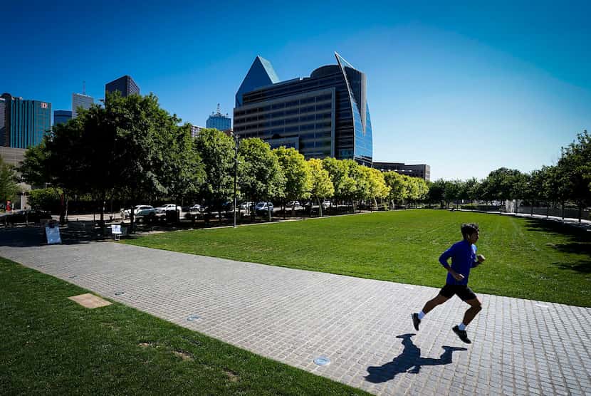 A runner had room to glide through the relatively empty Klyde Warren Park in Dallas on April...