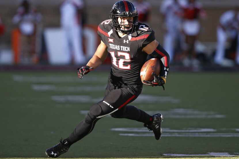 FILE - In this Oct. 31, 2015, file photo, Texas Tech wide receiver Ian Sadler carries the...
