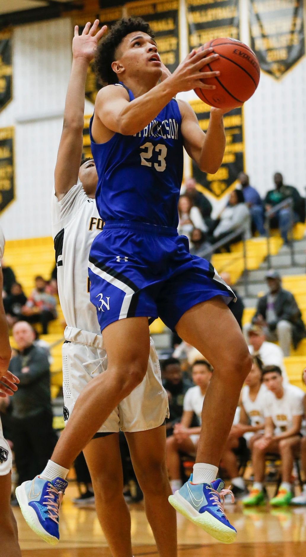 Byron Nelson High School Jakob Zenon (23) jumps with the ball toward the hoop during the...