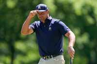 Bryson DeChambeau waves after making a putt on the second hole during the final round of the...