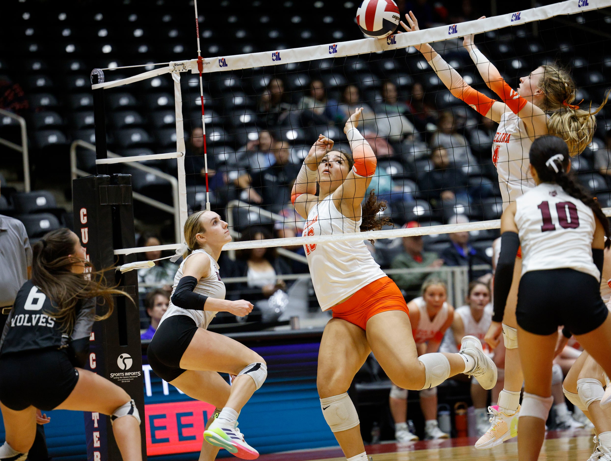 Celina's Selah Nickel (4) blocks a spike by Celina's Ryan McCoy (7), second from left, as...