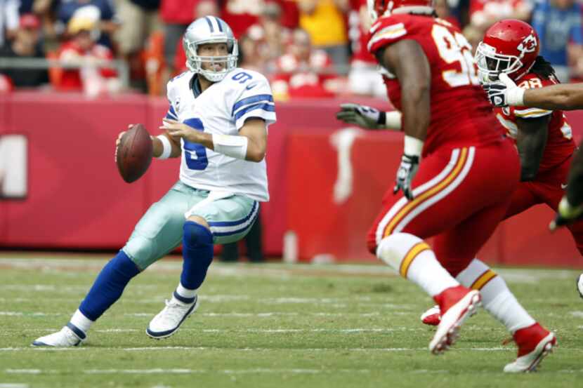 Dallas Cowboys quarterback Tony Romo (9) looks to pass as he is pressured by Kansas City...
