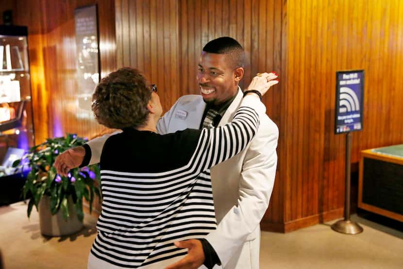 
Dale Moore (left) gives Dallas Summer Musicals house manager O’Shun Jackson a hug before a...