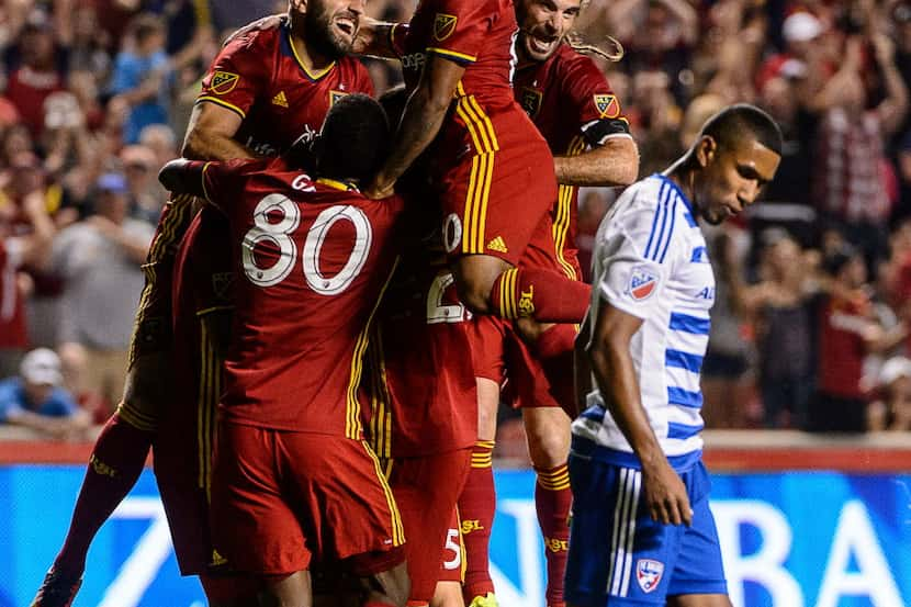 Real Salt Lake players jump on defender Jamison Olave (4) after his goal against FC Dallas...