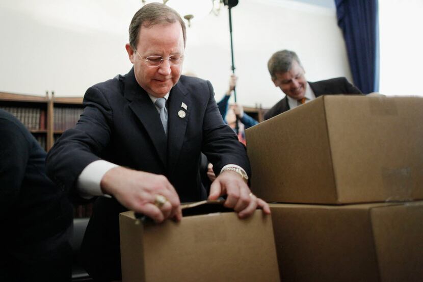 House Budget Committee member  Rep. Bill Flores used his keys to open boxes of President...