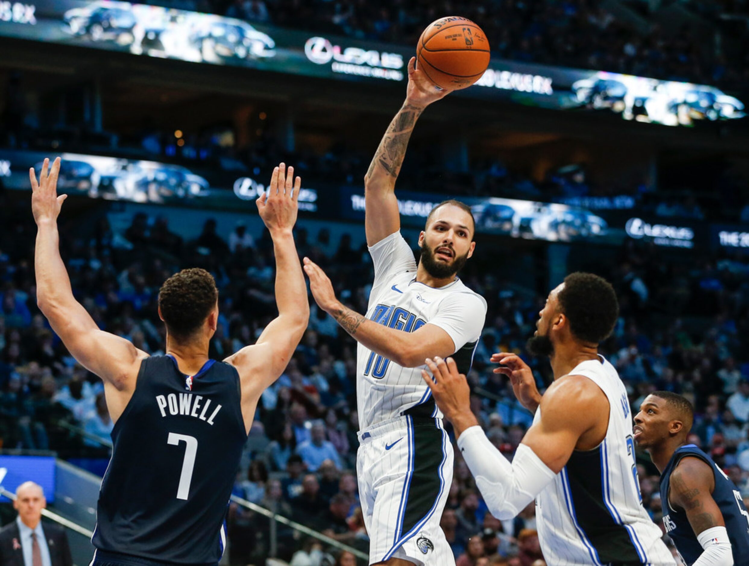 Orlando Magic guard Evan Fournier (10) fires off a pass over Dallas Mavericks forward Dwight...