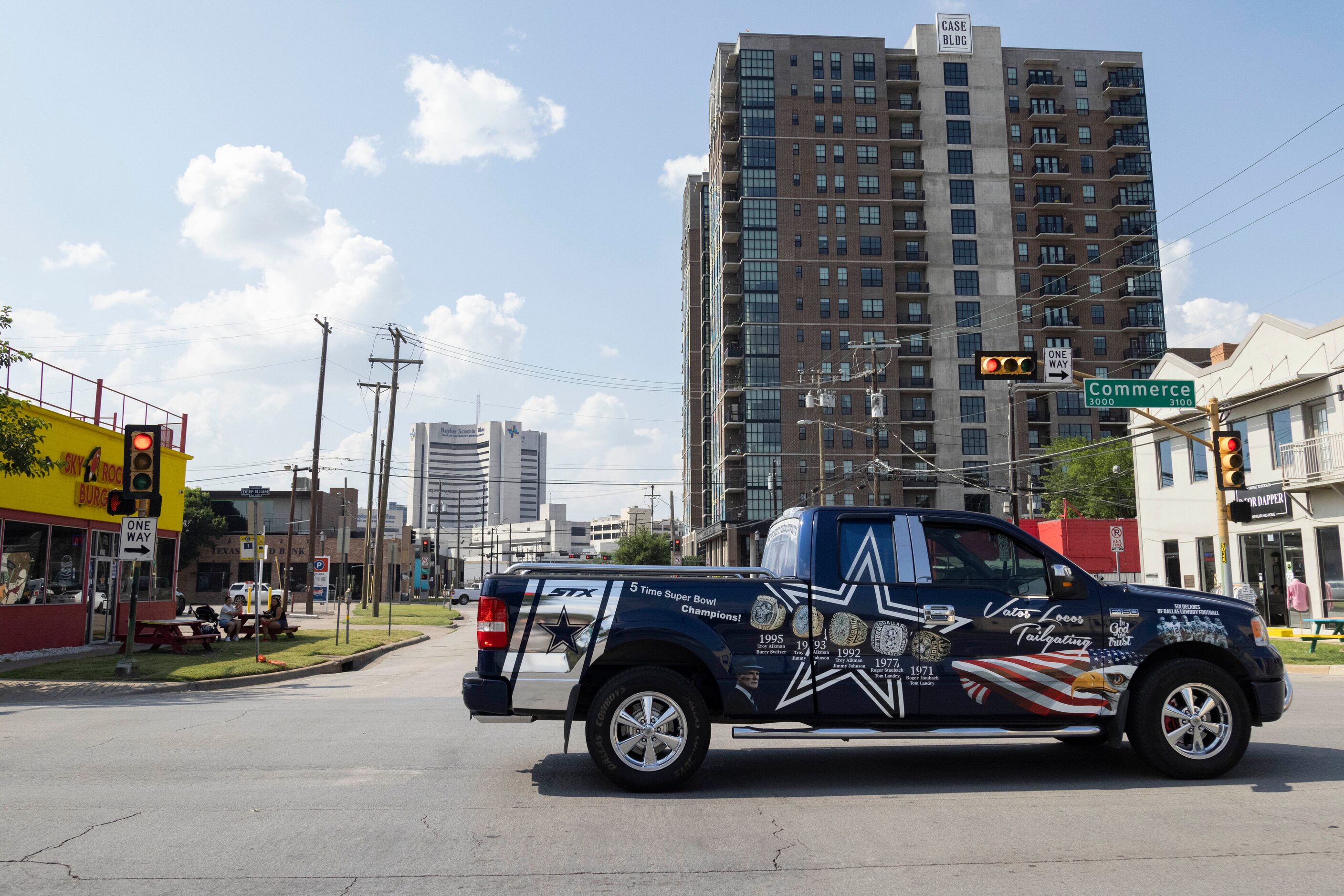 The Vatos Locos Tailgating Cowboys truck passes through the intersection of Commerce Street...