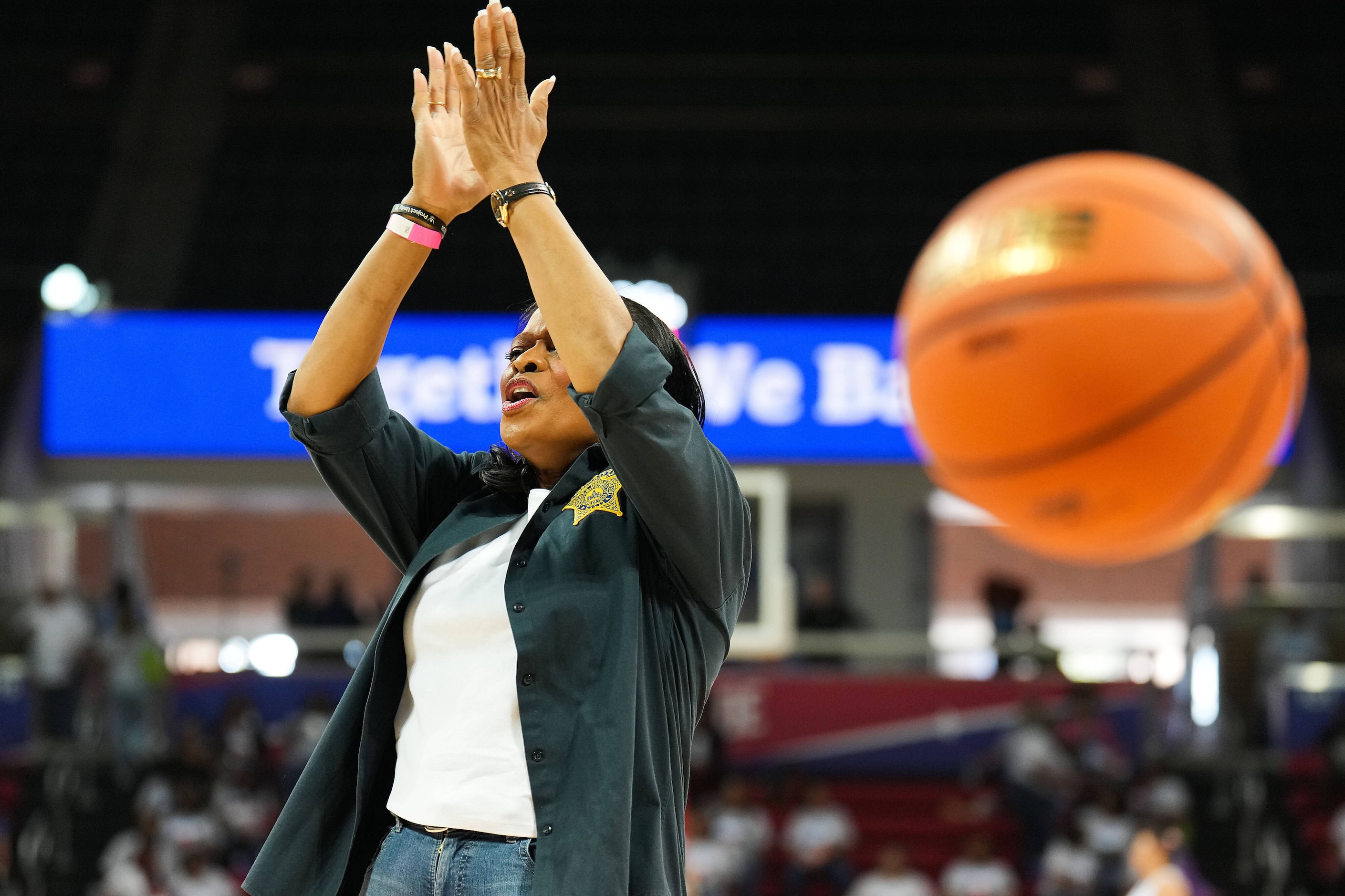 Dallas County Sheriff Marian Brown cheers a basket by DISD Police Chief Albert Martinez...