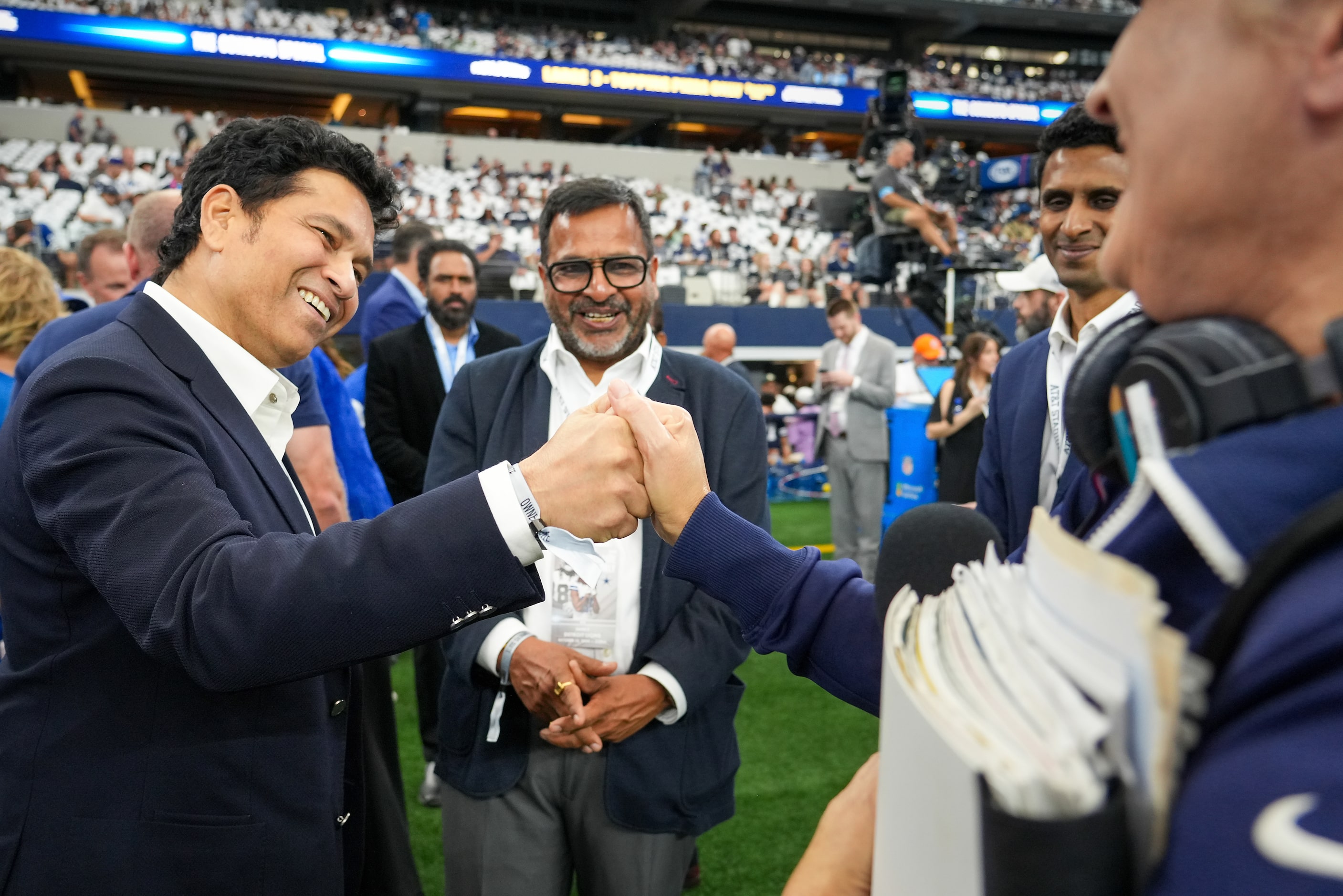 Cricket legend Sachin Tendulkar (left) greets Dallas Cowboys sideline reporter Kristi Scales...