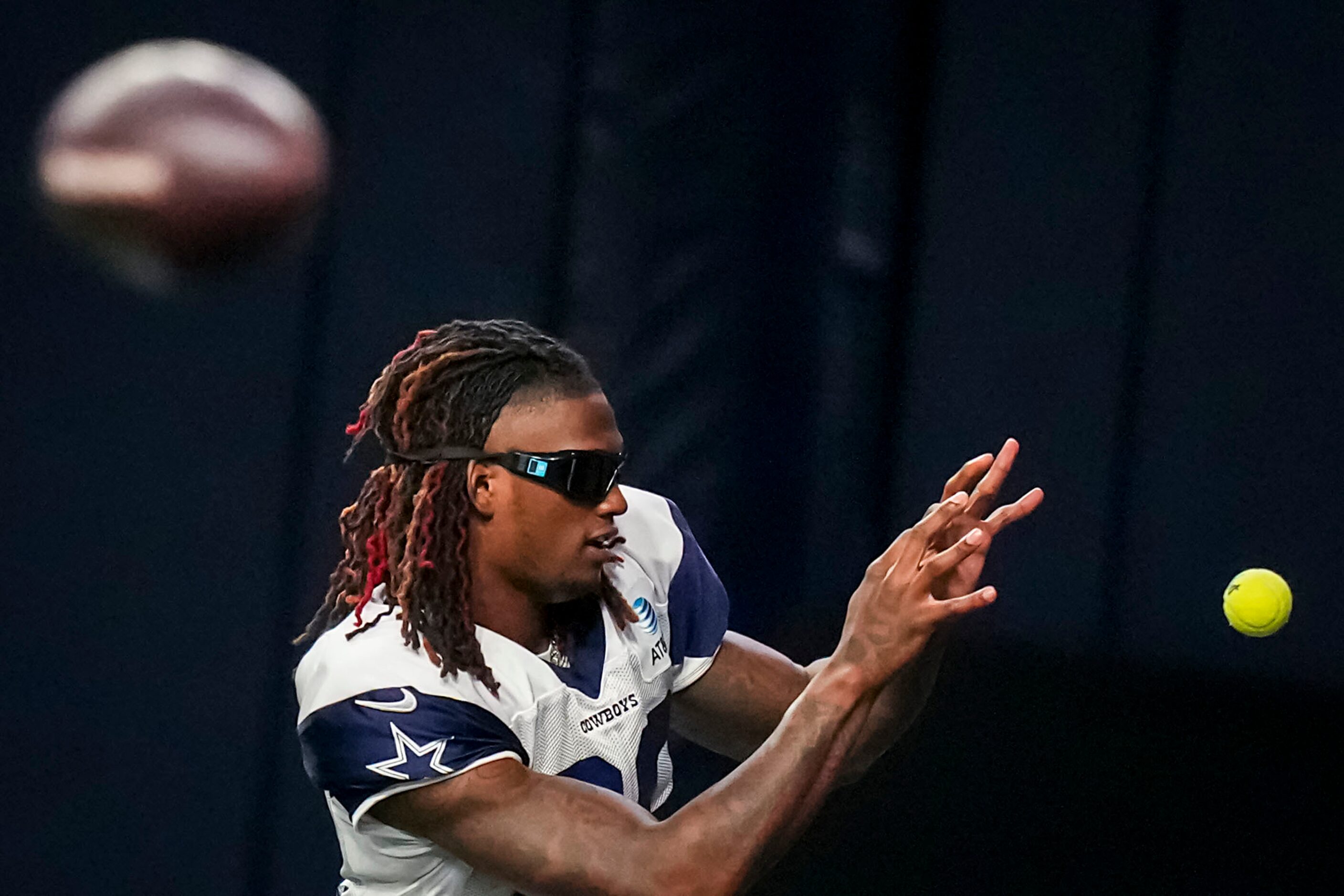 Dallas Cowboys wide receiver CeeDee Lamb caches a tennis ball during a training camp...