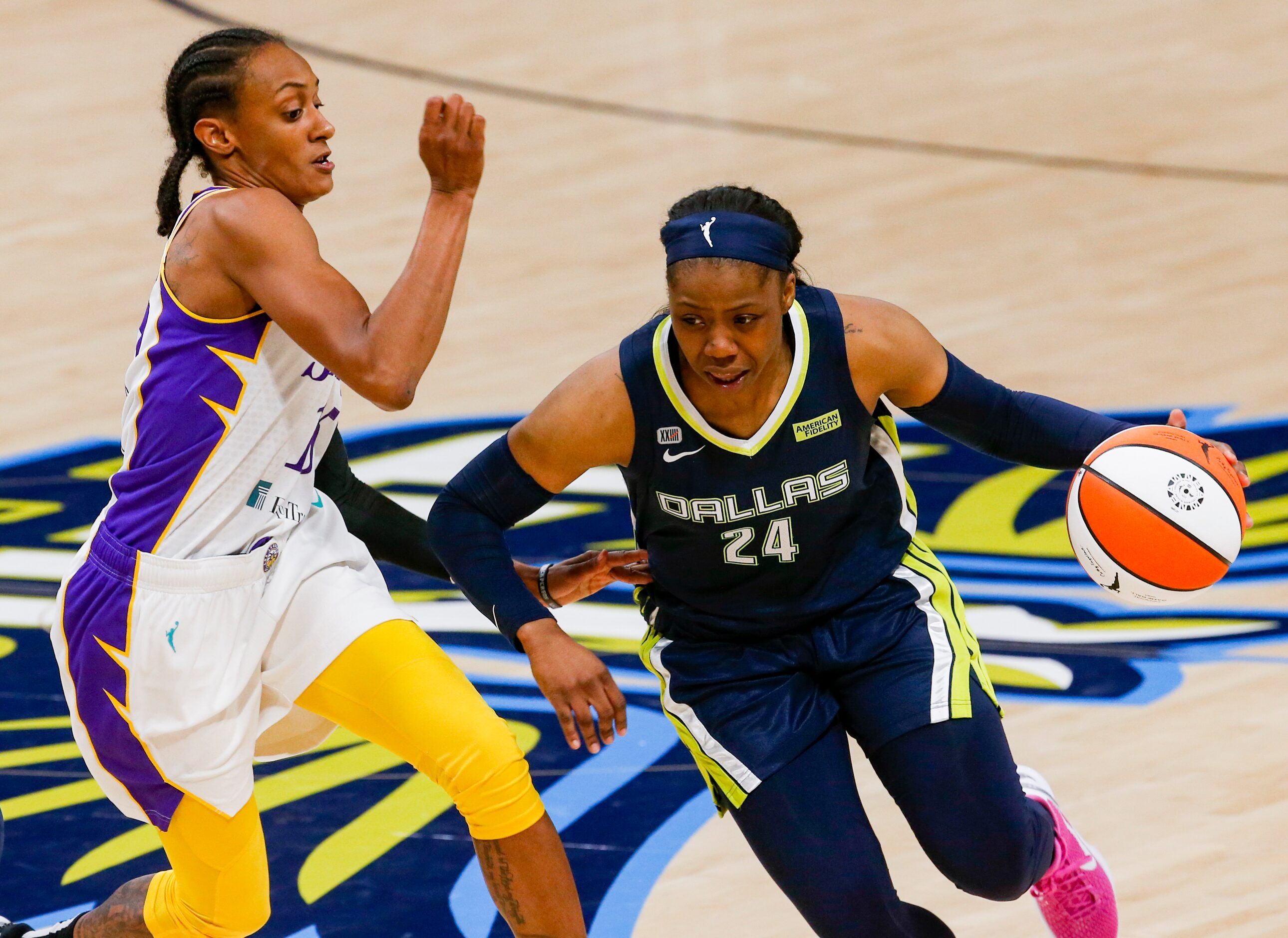 Dallas Wings guard Arike Ogunbowale (24) dribbles past Los Angeles Sparks guard Brittney...