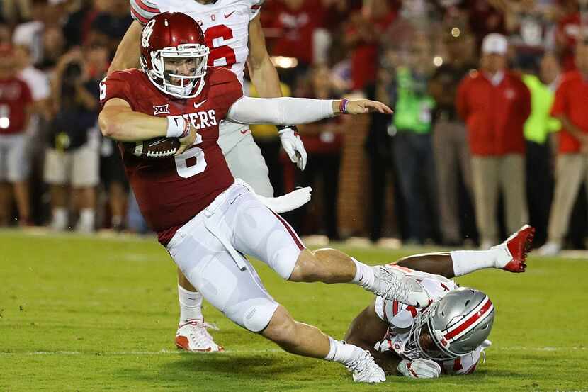 NORMAN, OK - SEPTEMBER 17:  Baker Mayfield #6 of the Oklahoma Sooners is tackled by Jerome...