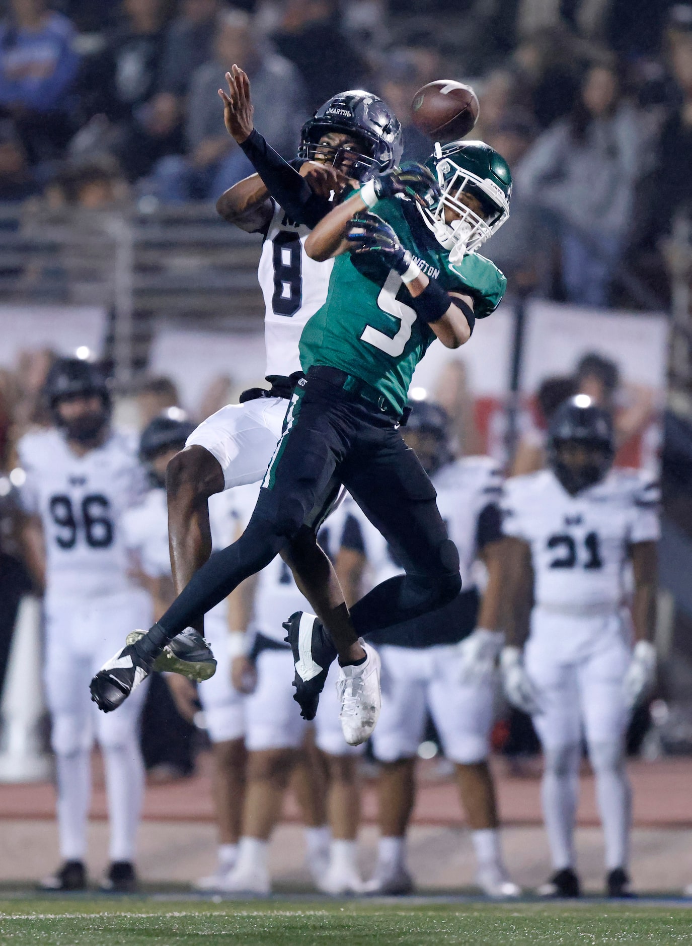 Arlington High wide receiver Izayah Donaldson (4) can’t hang onto a pass as he’s covered...