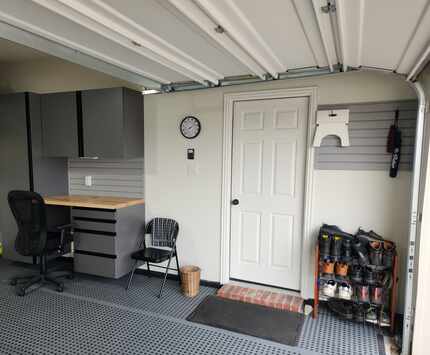 Garage entry with seating, shoe rack and slat wall for hanging items.