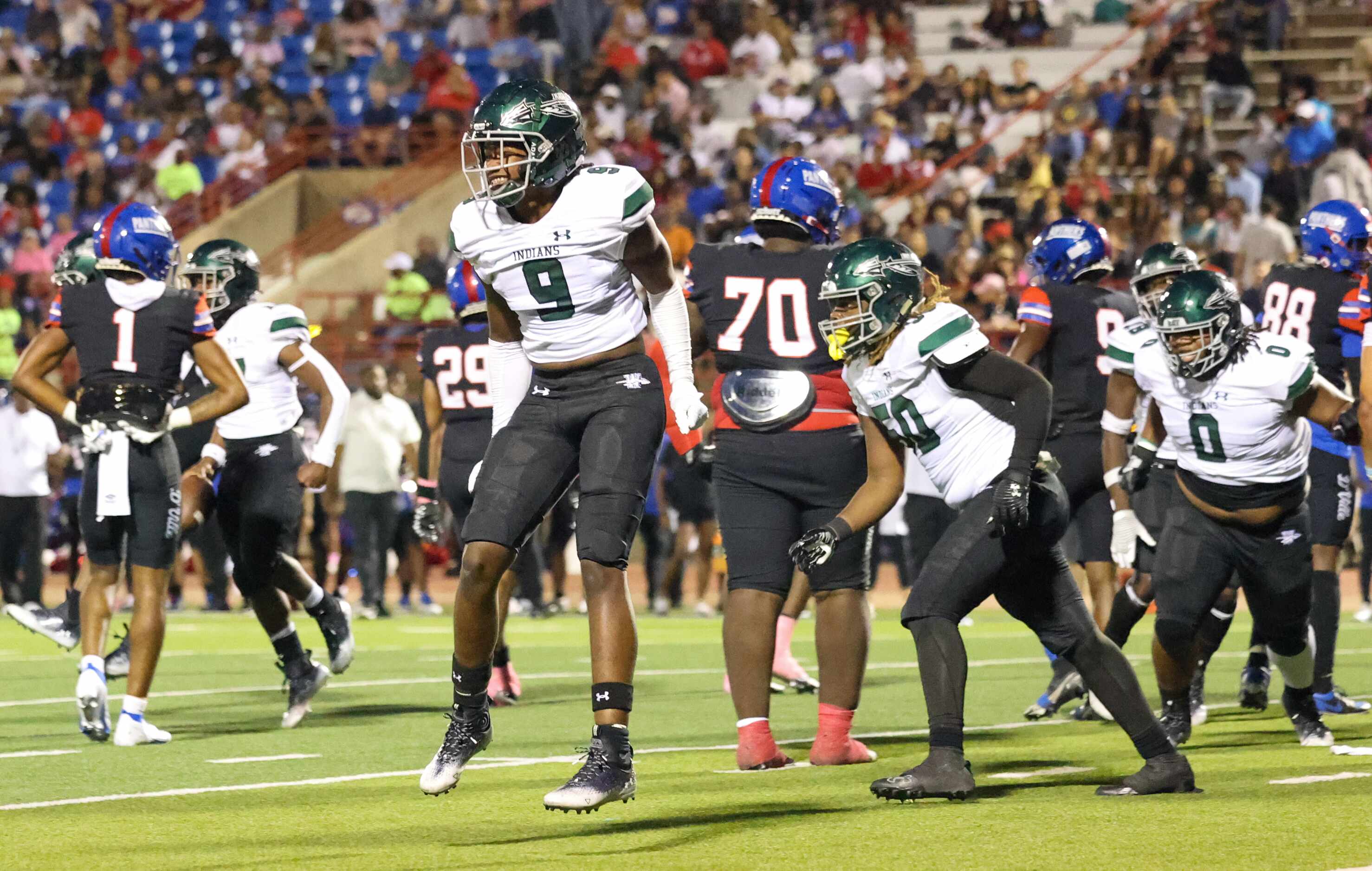 Waxahachie defensive end Garren Mason, Jr. (9) celebrates the team gaining control of the...