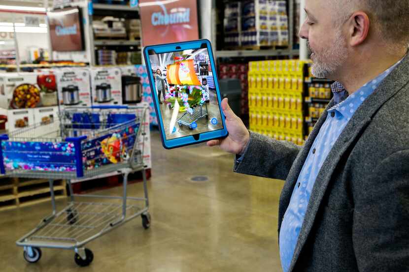 Eddie Garcia, vice president of end-to-end experience at Sam's Club, demonstrates features...