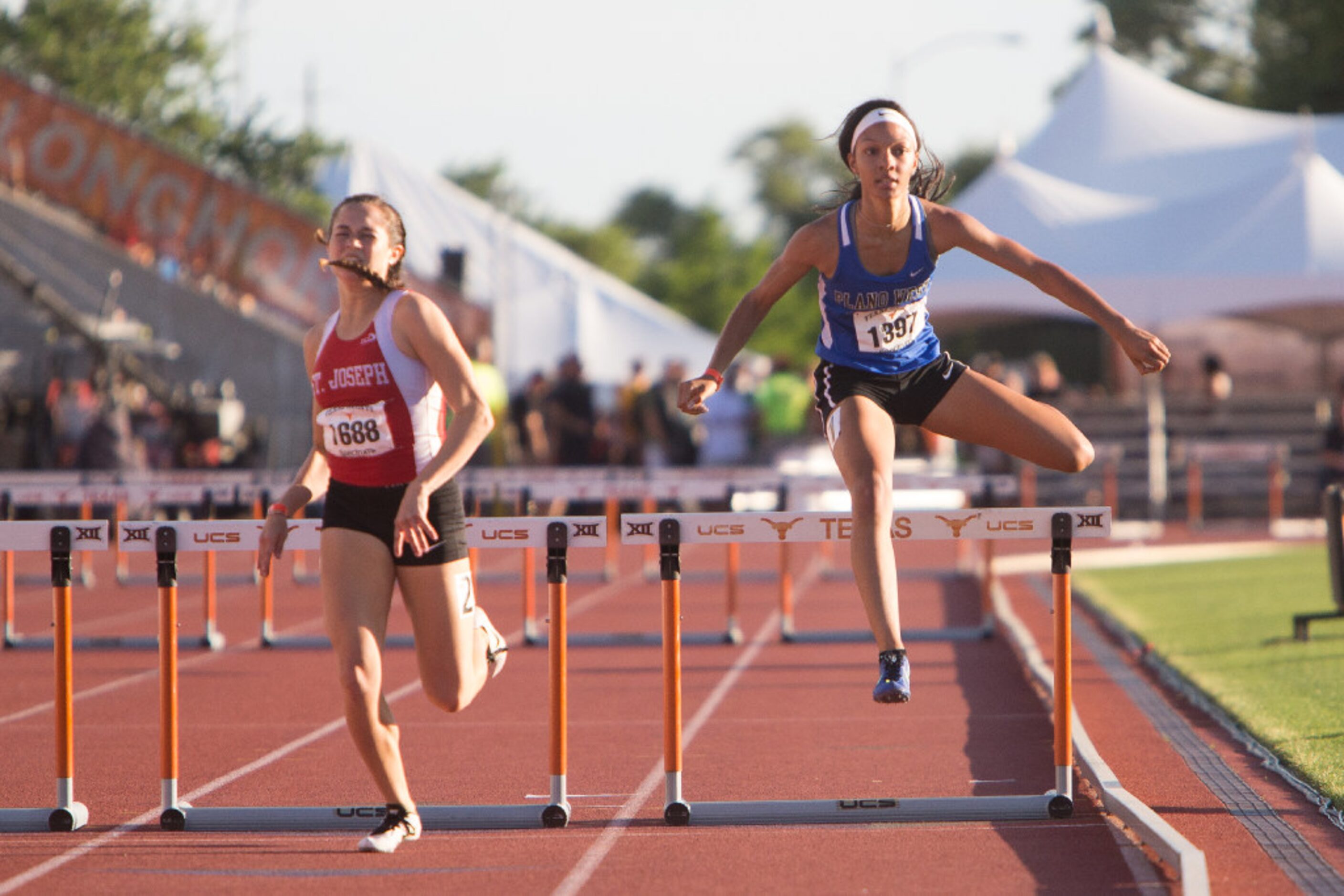 Plano West's Sharone' Jones, right, clears the last hurdle in the girls 300 meter hurdles...