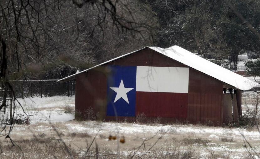  The Texas flag adorns a barn in southern Arlington. (2015 File Photo/Ron Baselice)