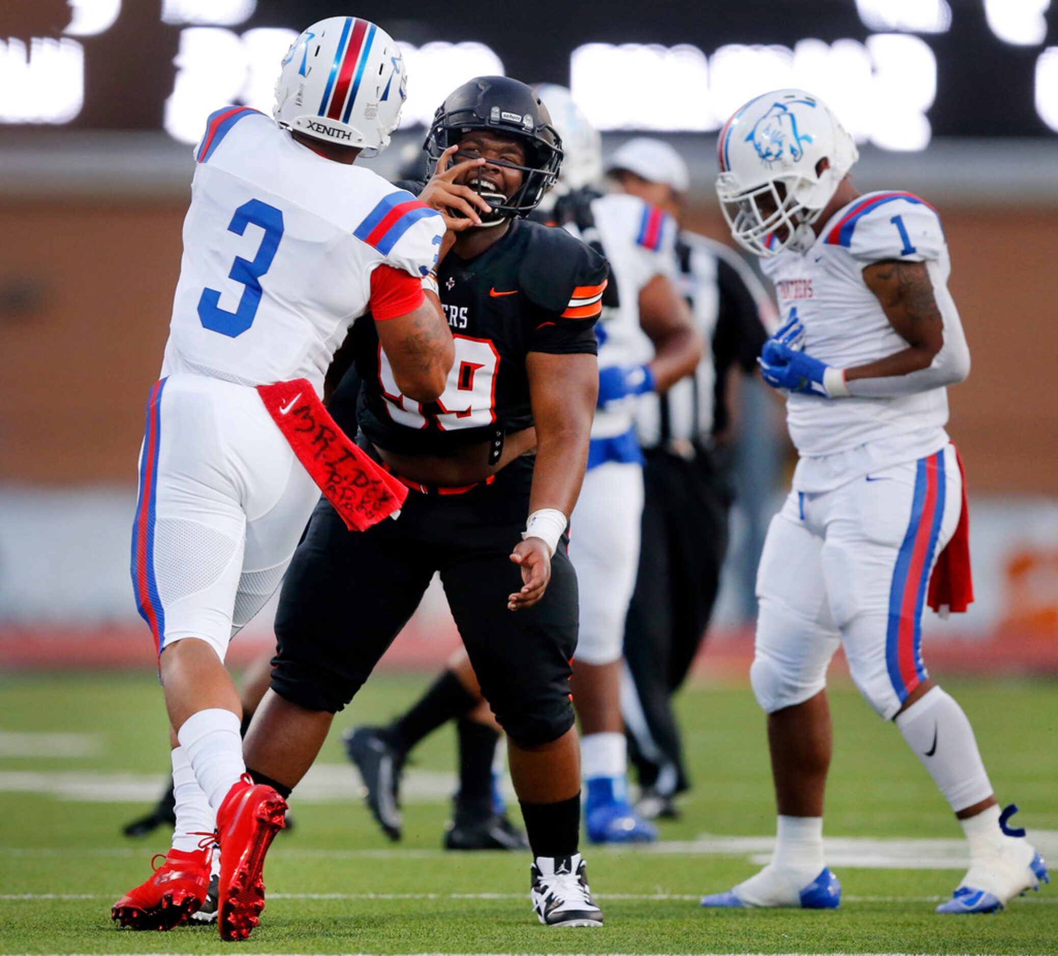 Duncanville quarterback Ja'Quinden Jackson (3) shoves Lancaster defensive lineman Dayven...