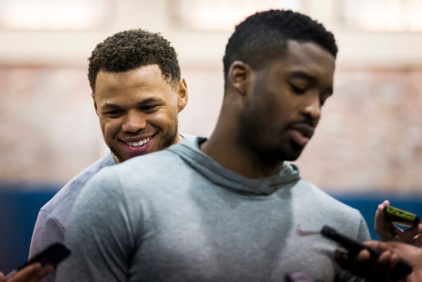 Dallas Mavericks guard Justin Anderson sneaks up behind guard Wesley Matthews as the team...