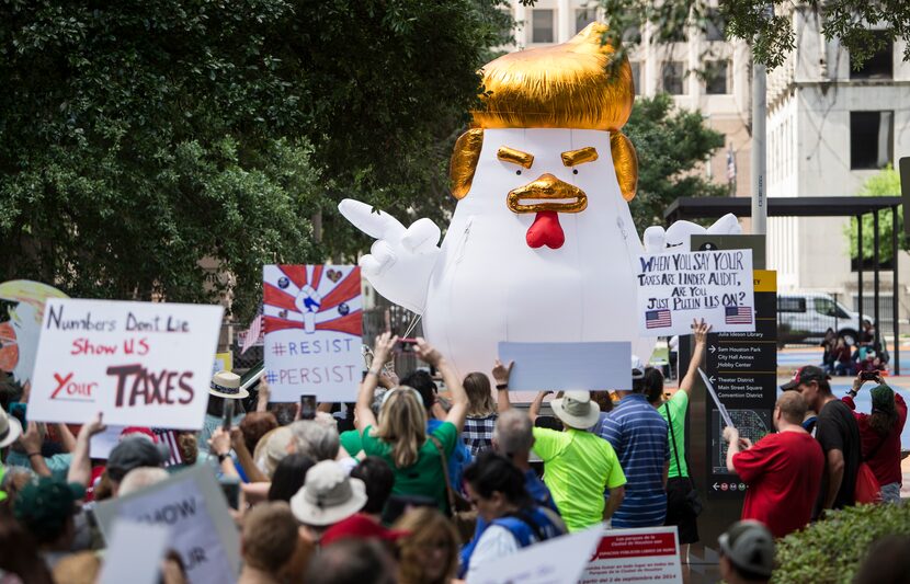 Demonstrators march through downtown Houston demanding greater governmental transparency and...