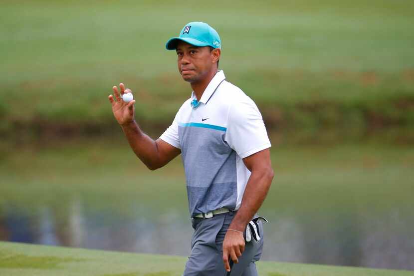 GREENSBORO, NC - AUGUST 20:  Tiger Woods reacts to a birdie putt on the 15th green during...