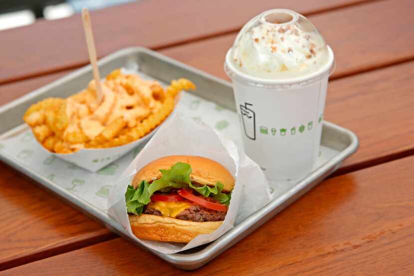 A photo of ShackBurger, cheese fries and Salted Toffee shake at Shake Shack in Plano, Texas,...