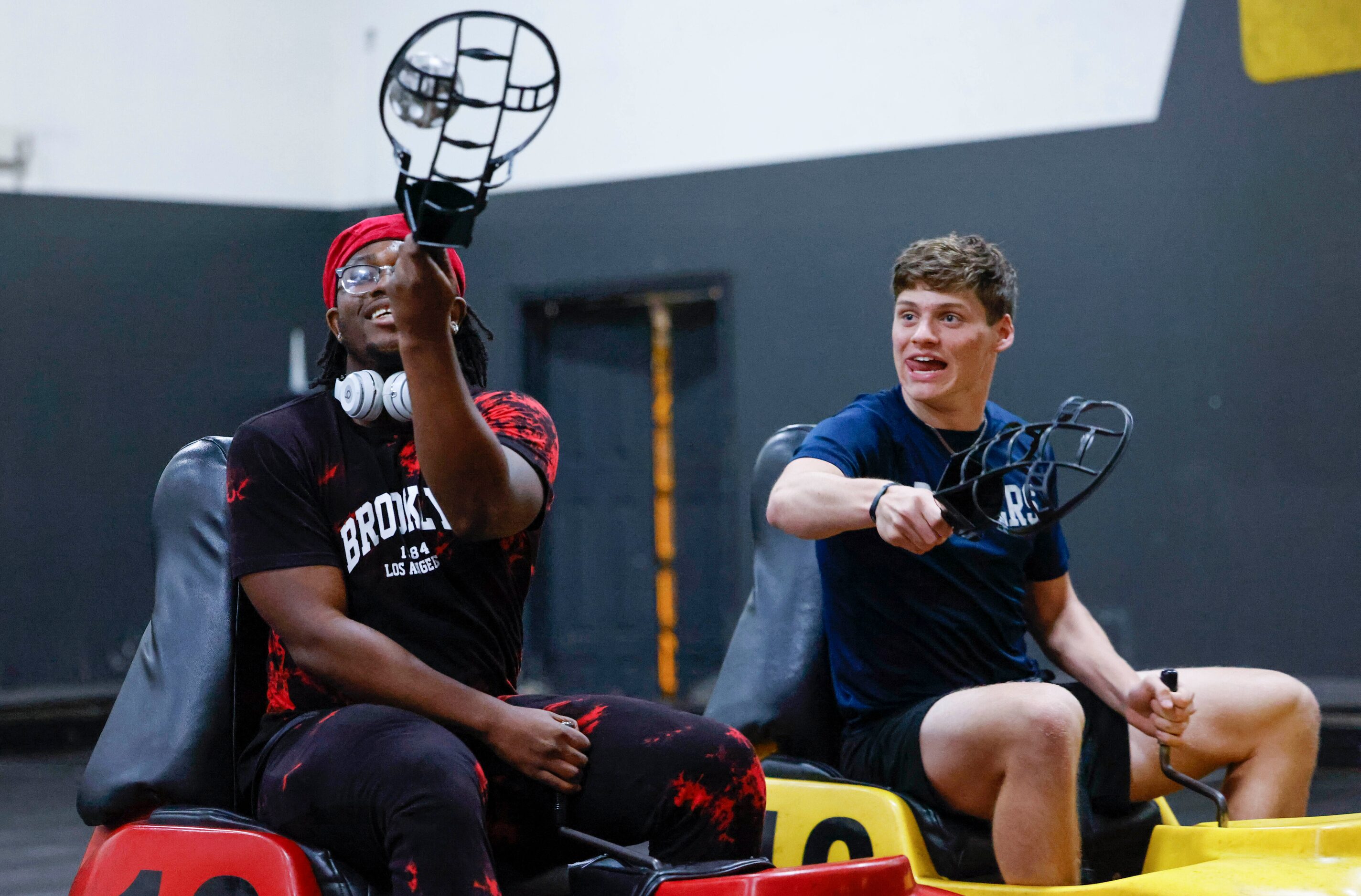 L.D. Bell High School football players Eugene Harris (left) holds the ball against Jon...