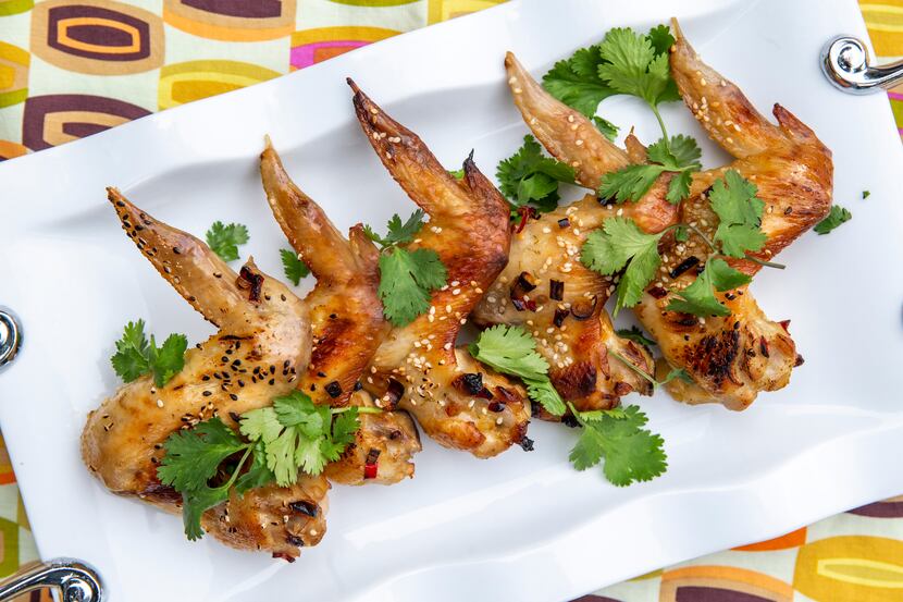 Glazed Sesame Chicken Wings dressed with cilantro and sesame seeds