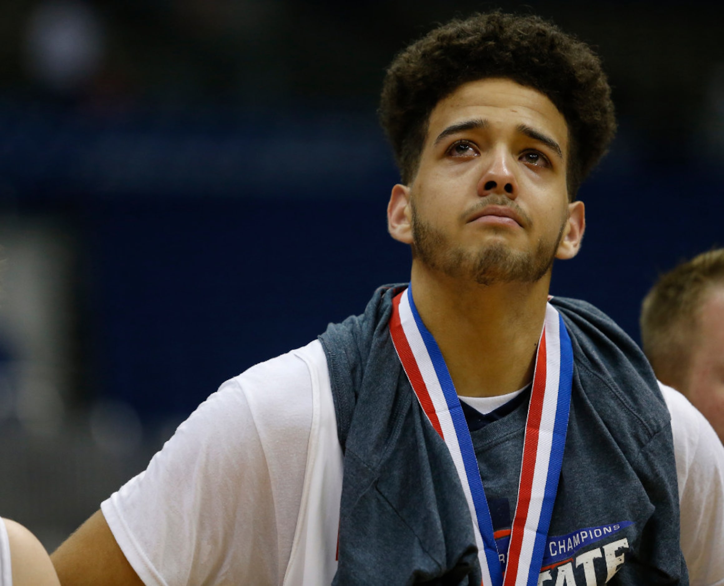 Justin Northwest's Jay Am'Mons (32) stands with his bronze medal after falling to Fort Bend...